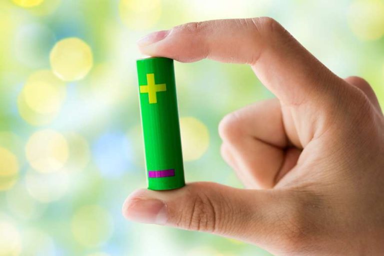 person holding green battery